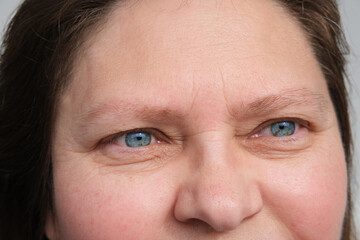 close up part of mature woman 50 years face, girl 20-29 years old, human eye, small wrinkles around...
