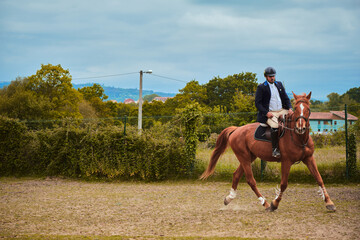 Dark-haired jockey jogging and preparing for an obstacle race, with copy space