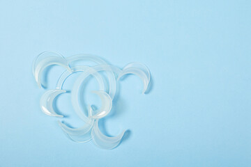 set of several Retractor Dental lip retractor Access to the oral cavity. Wide mouth opening for a dental procedure on a clean blue background