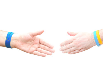 Two hands on a white background outstretched for a handshake.Template with empty place for text on the topics of consent and agreement.Bracelets in the color of the European Union and Ukrainian flags