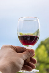glass of red wine in hand