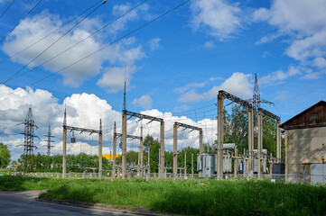 Fototapeta na wymiar high-voltage electrical substation against the blue sky