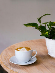 A cup of hot latte coffee on the table for breakfast
