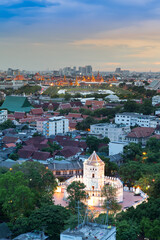 Fototapeta premium Ancient fortress tower with Grand Palace at Dusk (Bangkok, Thailand)