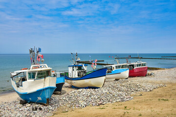 colorful fishing boats, a beach and the Baltic Sea in Poland