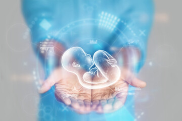 Medical concept, doctor's hands in a blue coat close-up and a hologram of a child. reproductive....