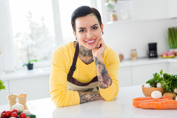 Portrait of young beautiful wife with piercing and tattoo prepare romantic dinner for her husband...