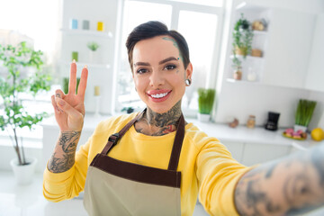 Photo of young charming woman with piercing and tattoo record video for her personal blog show...