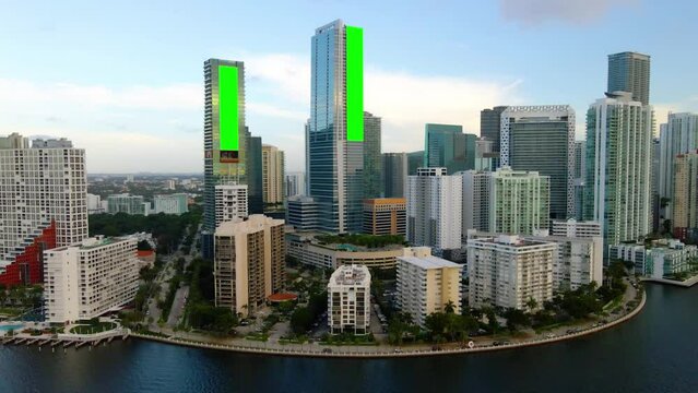 Aerial view of green screens placeholders on building walls in Brickell, Miami - 3D render