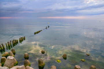 breakwater on the Baltic Sea, storm clouds and sunset