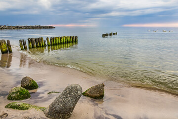 Fototapeta na wymiar breakwater on the Baltic Sea, storm clouds and sunset
