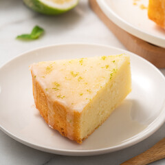 Delicious Lemon Glazed Pound Sponge cake on white marble table background.