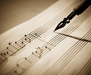 Music sheet, sheet music and feather, concept of composing music, music background