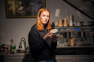 Barista girl near the coffee machine.