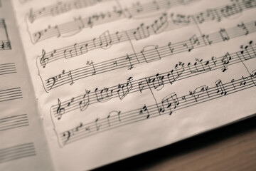 Fototapeta premium Symbols of notes on a musical stand, musical notation, musical background, selective focus