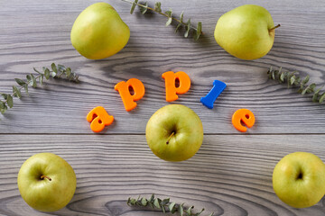 Ripe green apples on wooden grey table. Aerial top view.