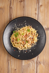 traditional dishes of European cuisine, delicacy, banquet snack. culinary dishes on a black plate on a wood background. restaurant service. top view