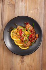 traditional dishes of European cuisine, delicacy, banquet snack. culinary dishes on a black plate on a wood background. restaurant service. top view