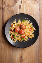 traditional dishes of European cuisine, delicacy, banquet snack. culinary dishes on a black plate on a wood background. restaurant service. top view