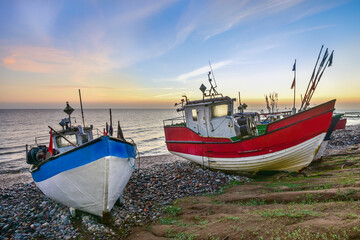 colorful fishing boats in the first rays of sun, the Baltic Sea in Poland