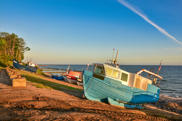colorful fishing boats in the first rays of sun, the Baltic Sea in Poland