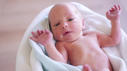 newborn. baby newborn close-up lies looking at the camera in the hospital maternity hospital. happy...