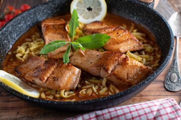 pan seared salmon fillet with cream sauce and spaetzle noodles