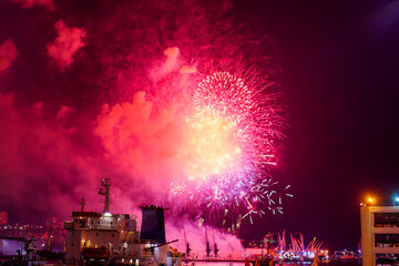 Fireworks over the bay and port of the city. Vladivostok, Russia