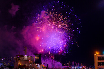 Fireworks over the bay and port of the city. Vladivostok, Russia