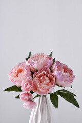 Pink peony flowers bouquet on white background with copy space. Womens day or wedding concept.