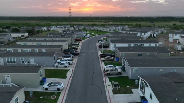 Modern manufactured homes in USA. Hispanic neighborhood in America. Aerial pullback reveal.