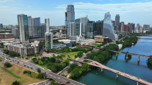 Austin Texas cityscape skyline panorama. Aerial pullback reveals bridges over Colorado River.