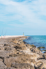 Fototapeta na wymiar Long breakwater next to the beach, an ideal place for fishing.