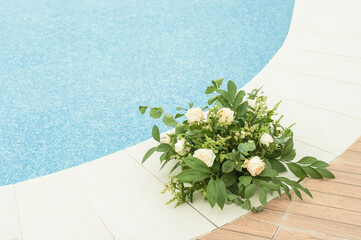 Beautiful decorative bouquet of tiny flowers by the swimming pool.