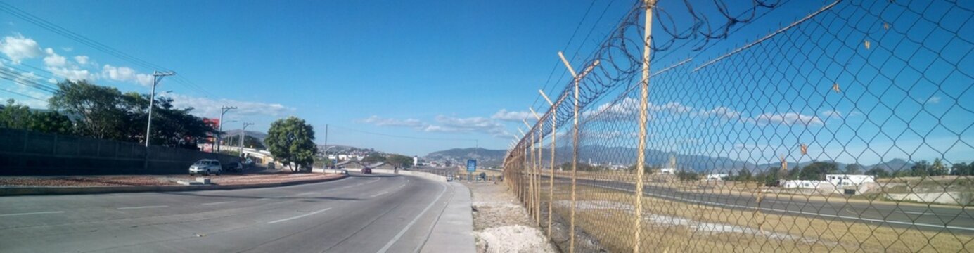 carretera con malla divisoria con cielo azul