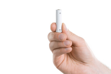 Close up image of mans hand holding battery on white background