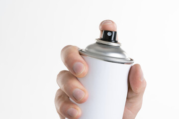 Man's hand holds a can of aerozols isolated on white background