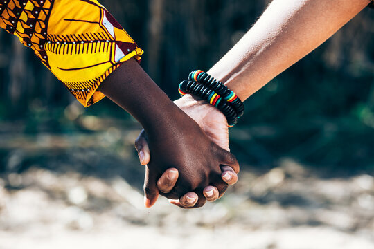 Crop loving couple holding hands