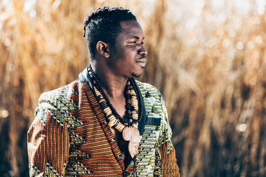 African man in beaded jacket near field