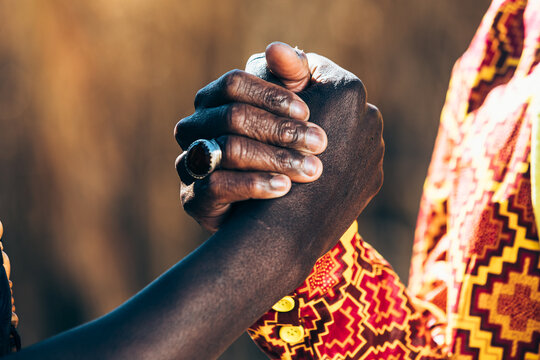 Crop African people shaking hands