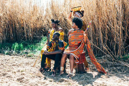 Stylish tribal people near field in countryside