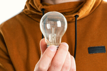 A close up image of man holding light bulb
