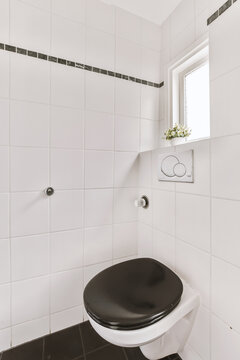 Bathroom with white ceramic tiled walls and toilet bowl