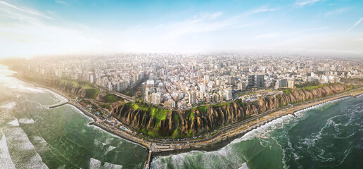 Scenic cityscape with contemporary multistory buildings and wavy ocean