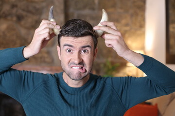 Man with pair of growing horns 