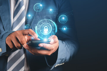 Fototapeta premium cybersecurity concept Business man shows how to protect cyber technology network from attack by hackers on the internet. Secure access to privacy through smartphones Meta protection. 