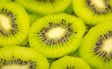 Kiwi closeup as background. Ripe kiwi fruit in the cut. Kiwi seed texture.