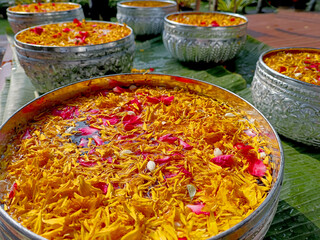 Flower water filled with colorful flowers is held in a container for hand watering to the elderly. The concept of traditional Songkran traditions of Thailand.