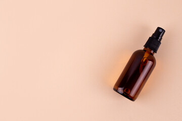 Unbranded bottle with dispenser. Brown glass container with oil for body and hair. Mockup style design. Cosmetology and beauty concept