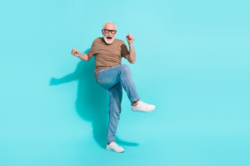 Full length body size view of attractive cheerful crazy grey-haired man having fun isolated over bright blue color background